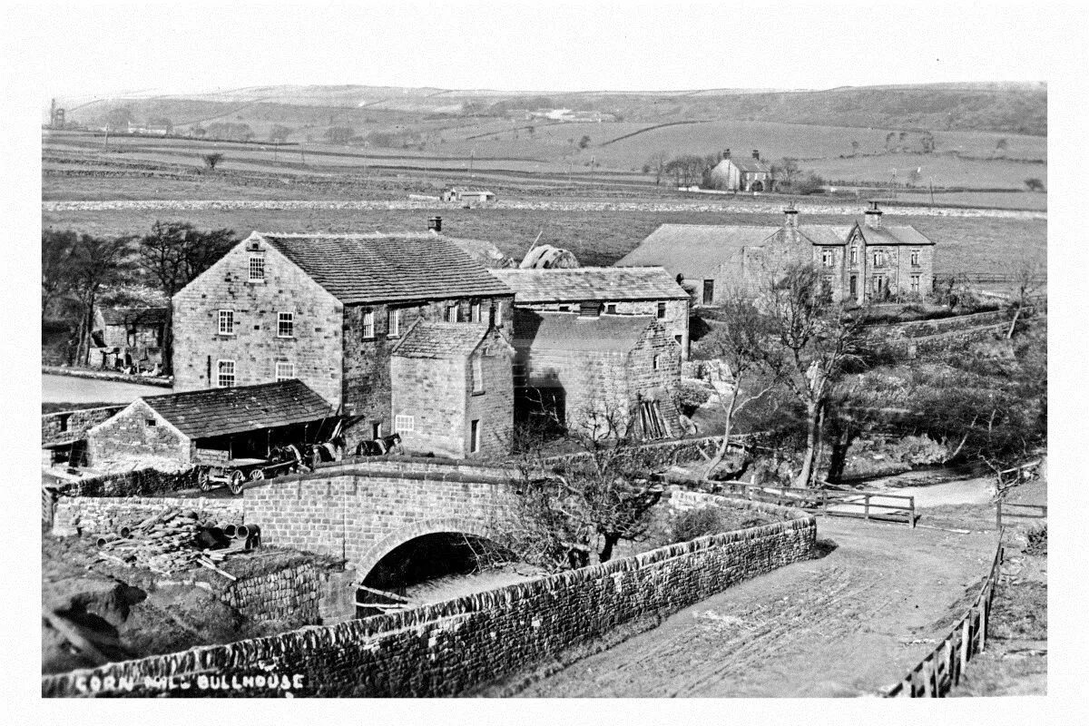 Historic photograph of Bullhouse Corn Mill, the stone bridge and the mill house
