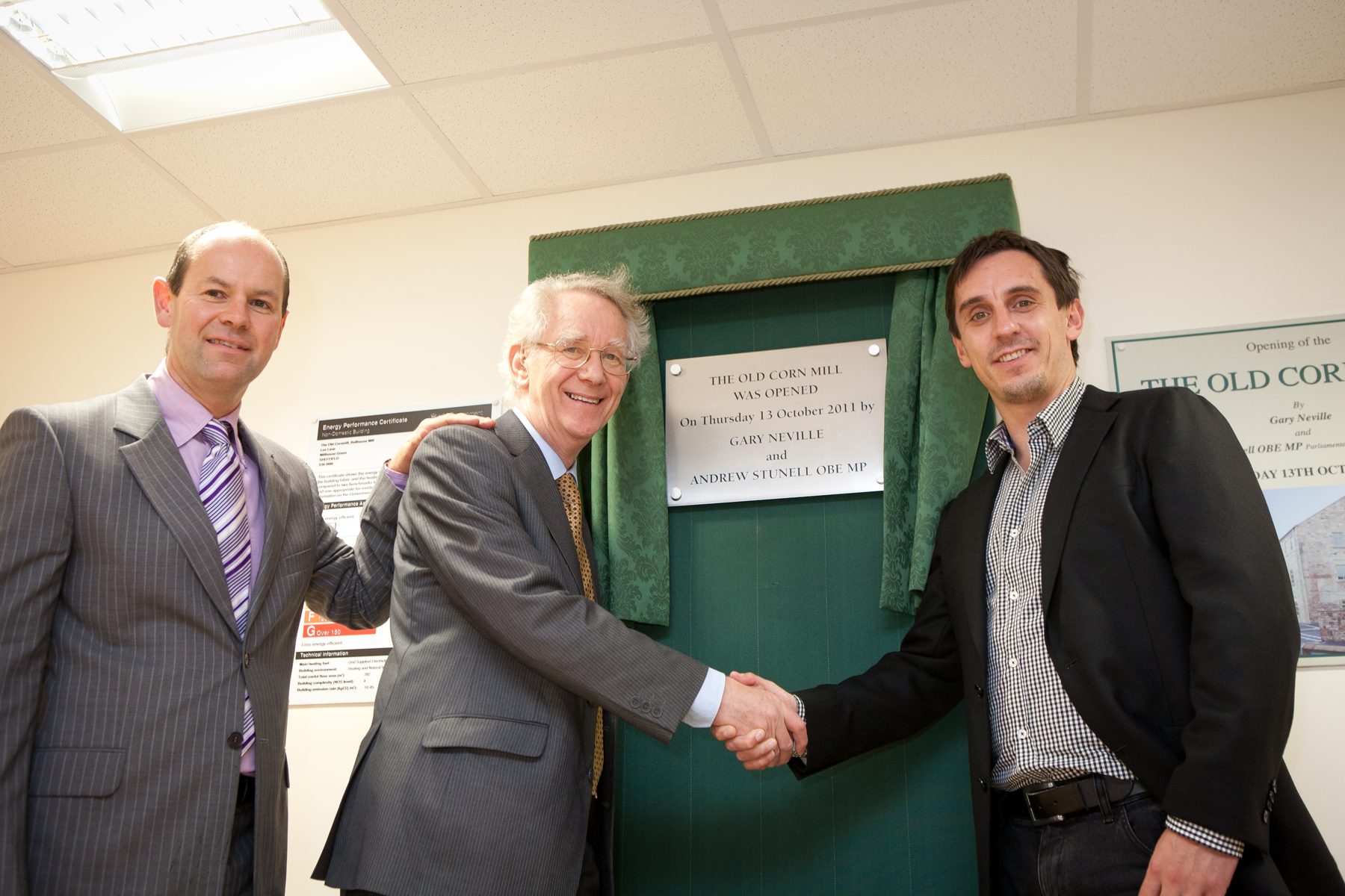Gary Neville and Andrew Stunell OBE MP beside the plaque marking the opening of the Old Corn Mill