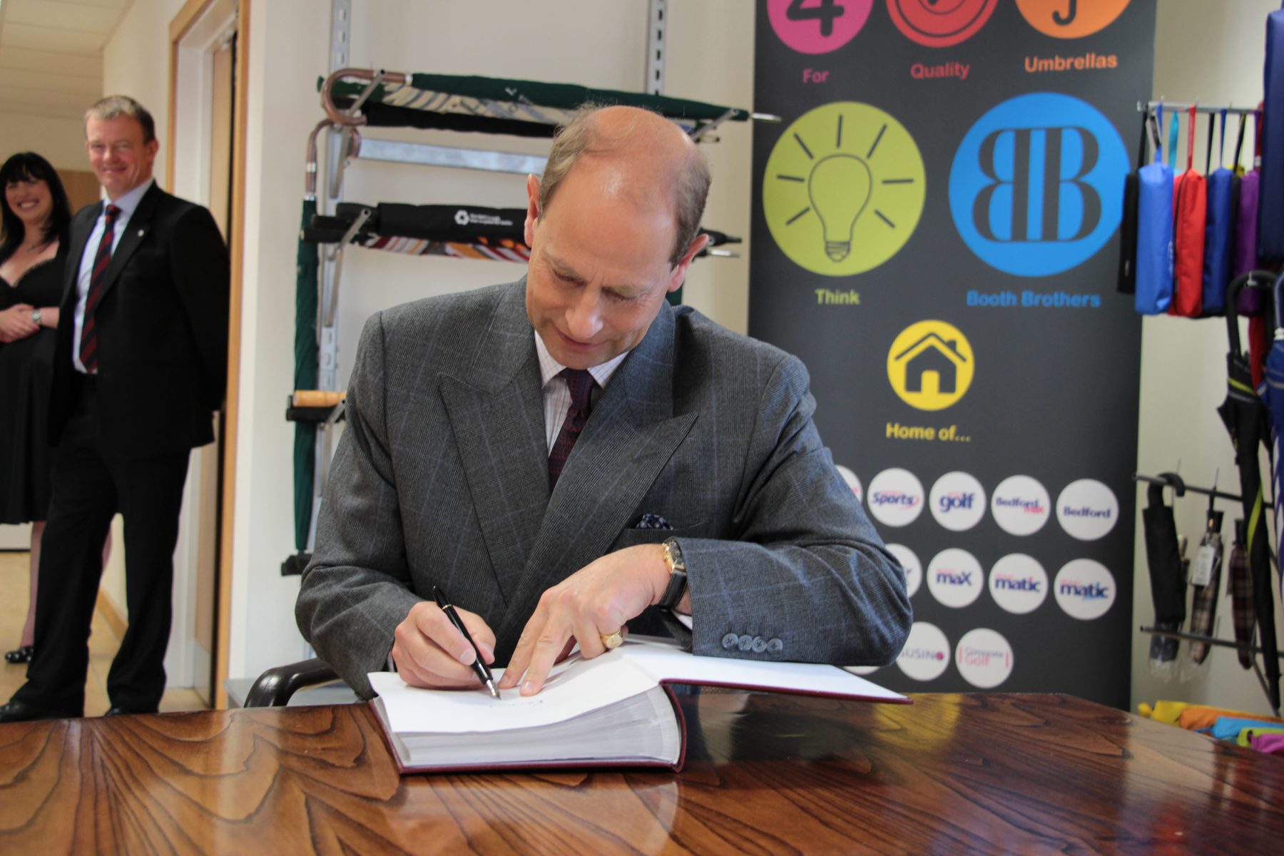 The royal visitor signing the visitors' book at Bullhouse Mill in 2013