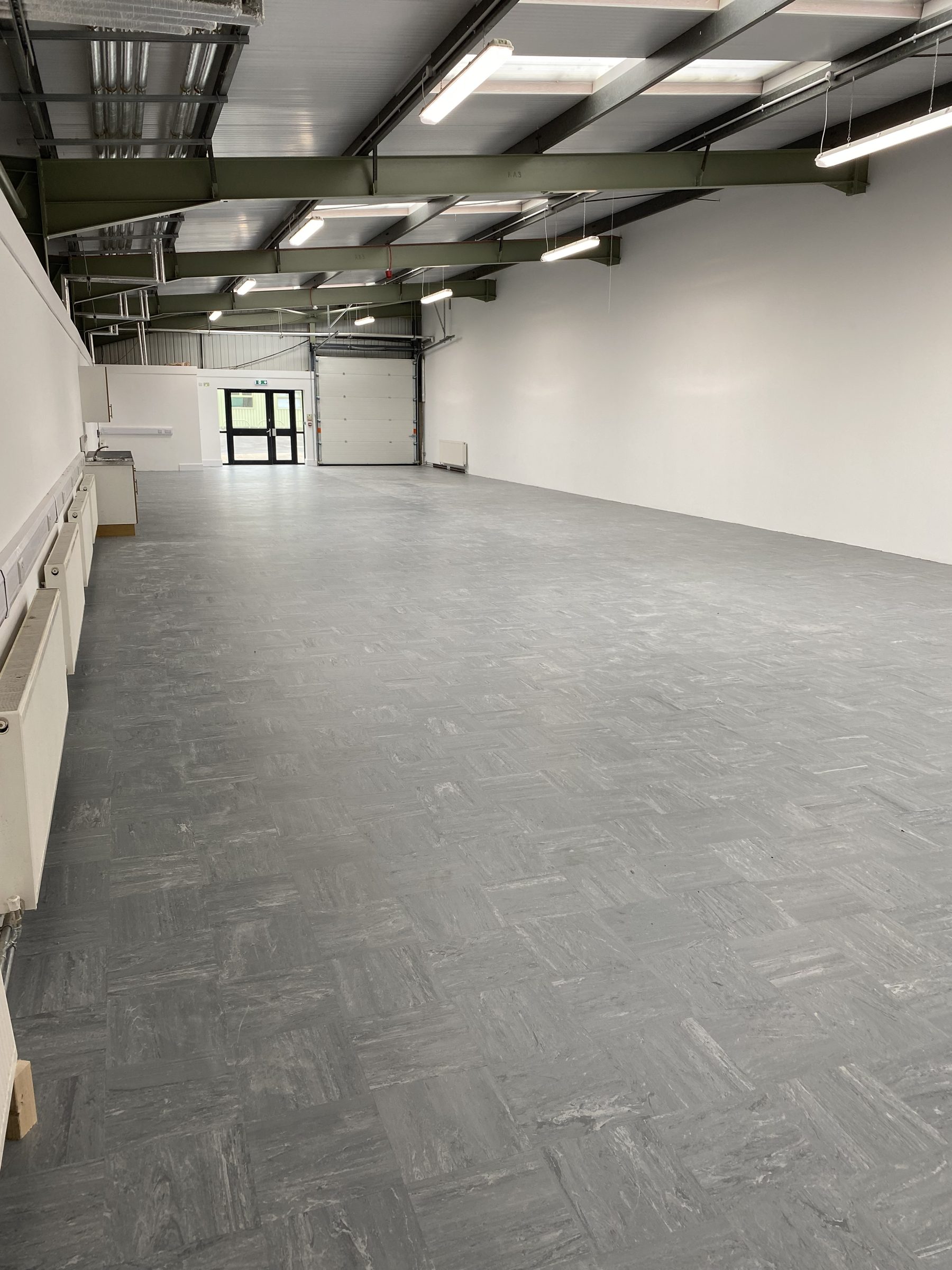 Inside a unit: open floor, kitchenette and roller door